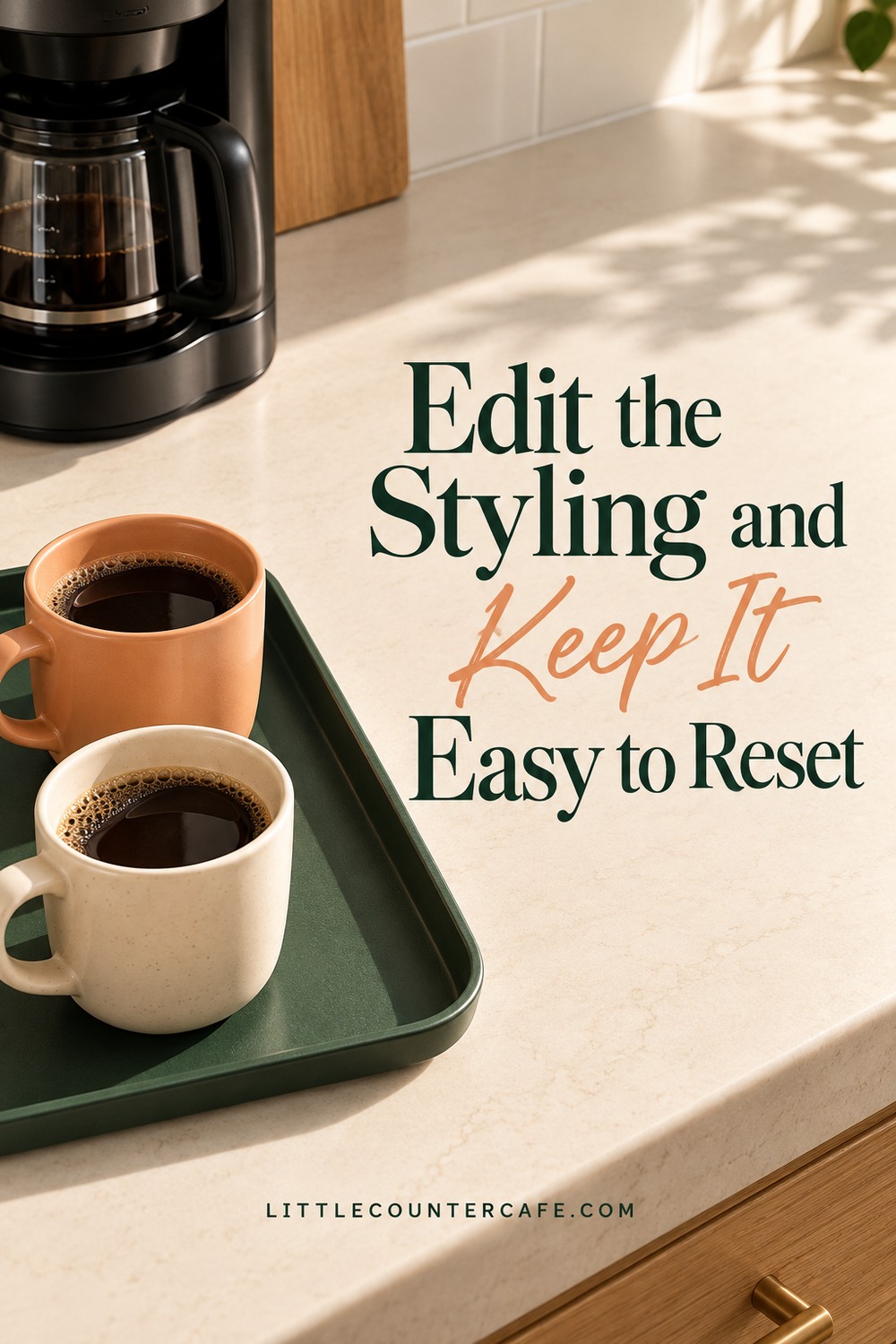 Concept green tray with peach and cream cups beside a broad clear countertop and a black drip coffee maker.