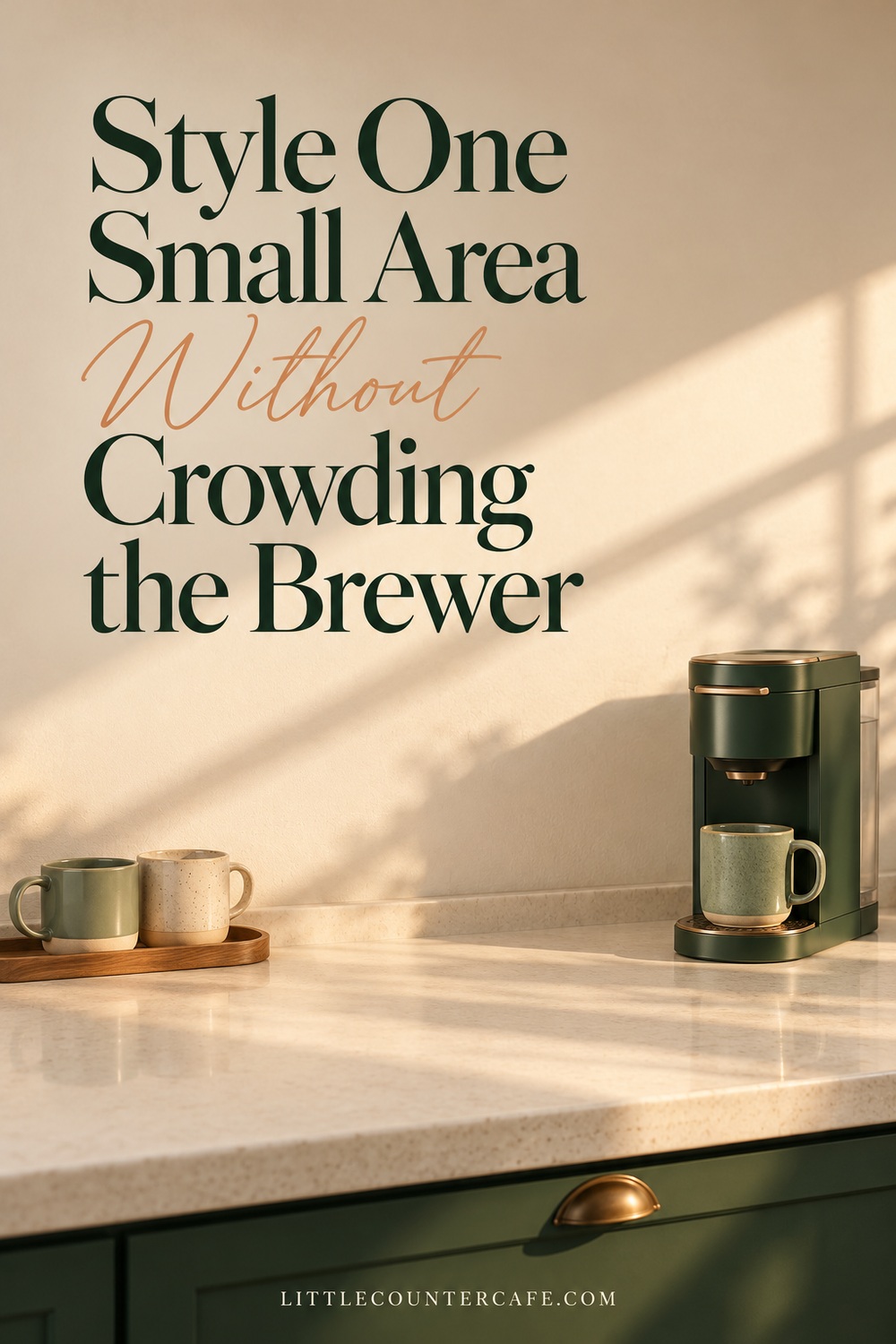 Compact green brewer at one end of a clear counter, with two mugs on a separate tray.