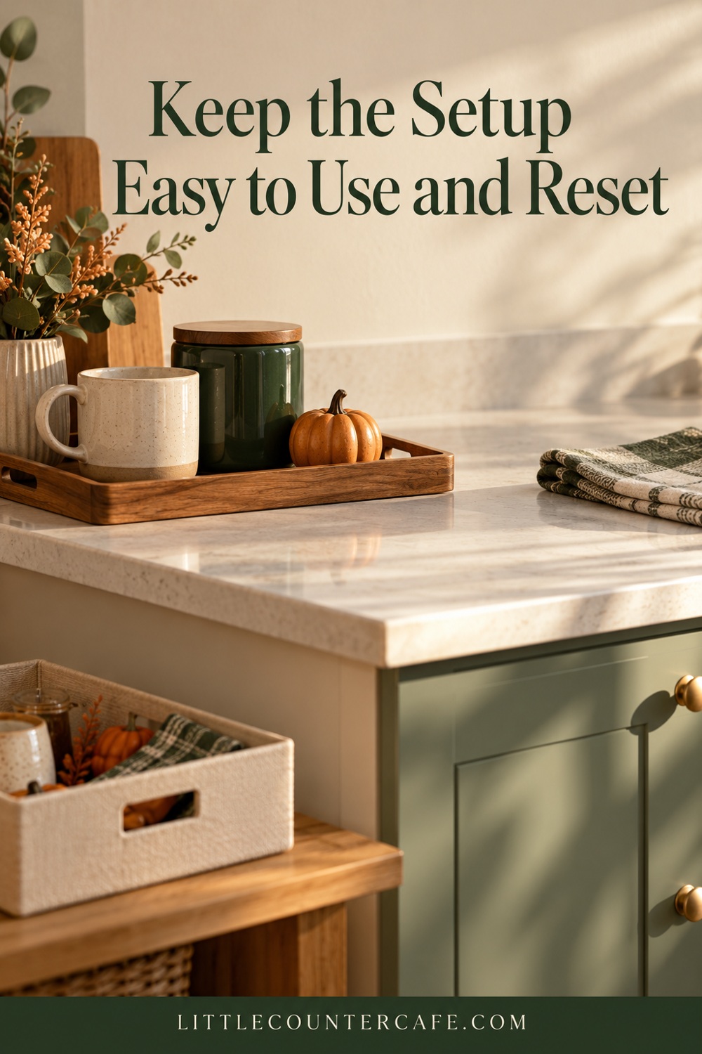 Mug, green jar and pumpkin on a tray beside clear counter space, folded cloth and storage box.